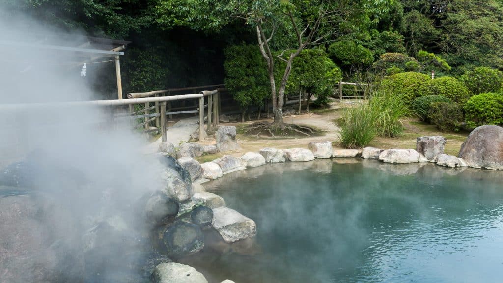Steam rising from a hot spring in Beppu, Japan