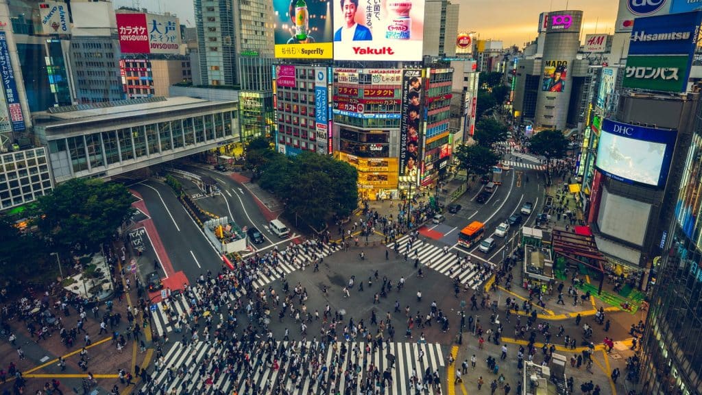Shibuya crossing in Tokyo seen from above, filled with pedestrians