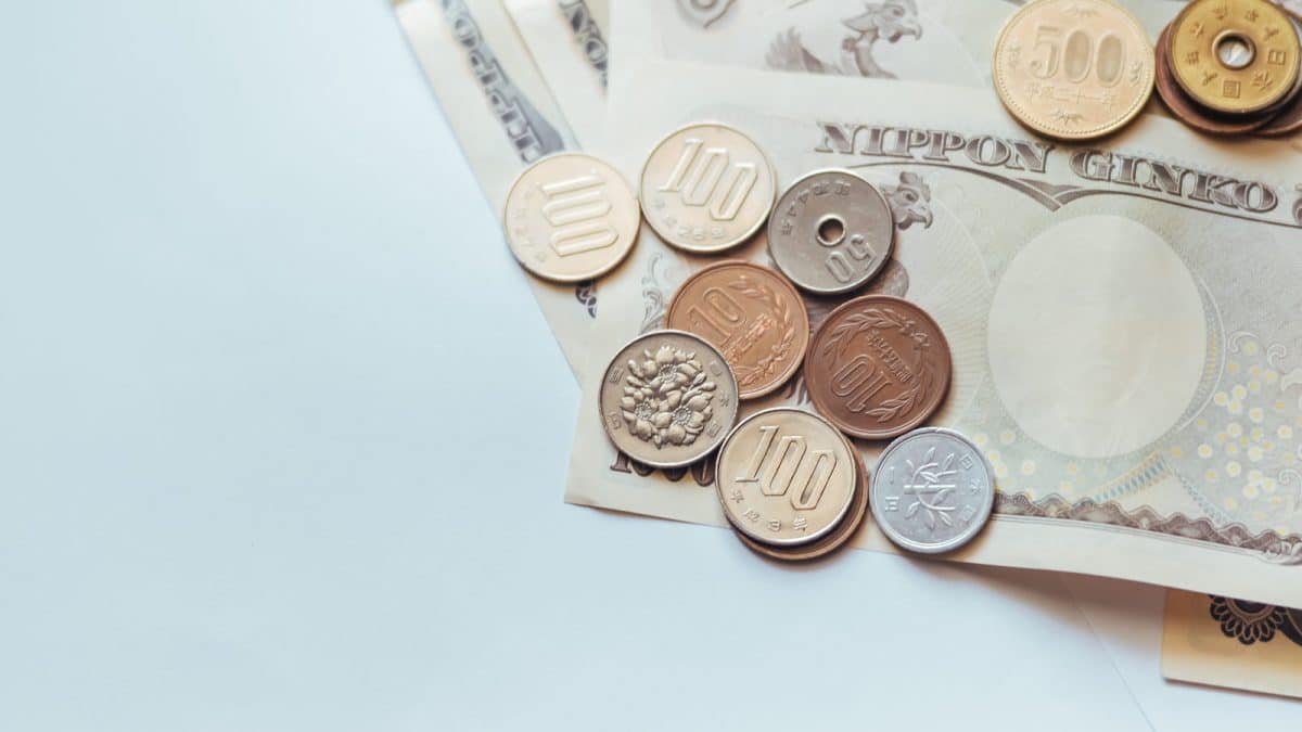 Japanese yen banknotes and coins laid out on a surface