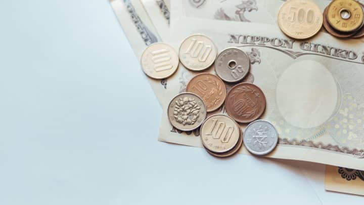 Japanese yen banknotes and coins laid out on a surface