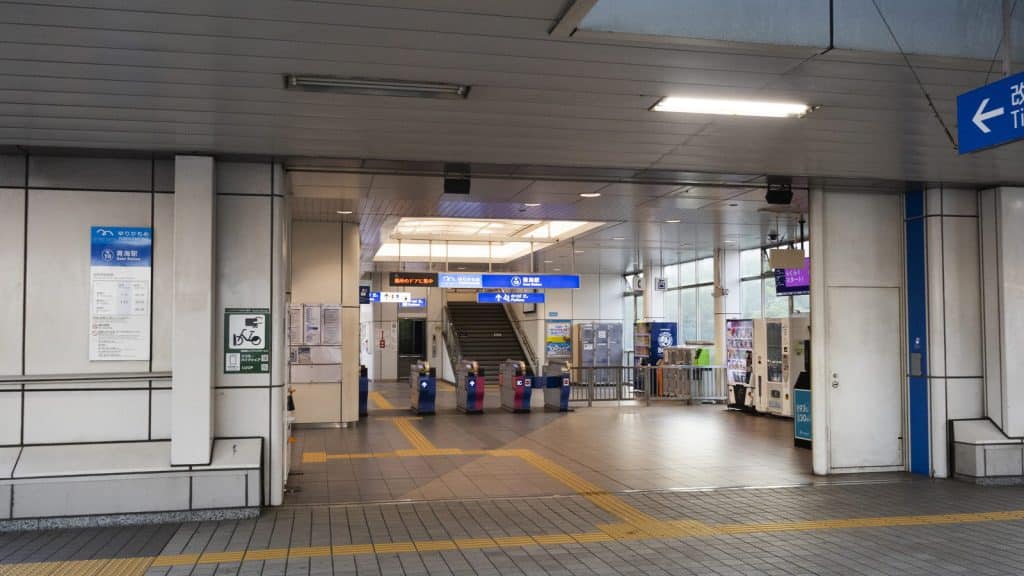 The interior of a Tokyo railway station with passengers on the concourse