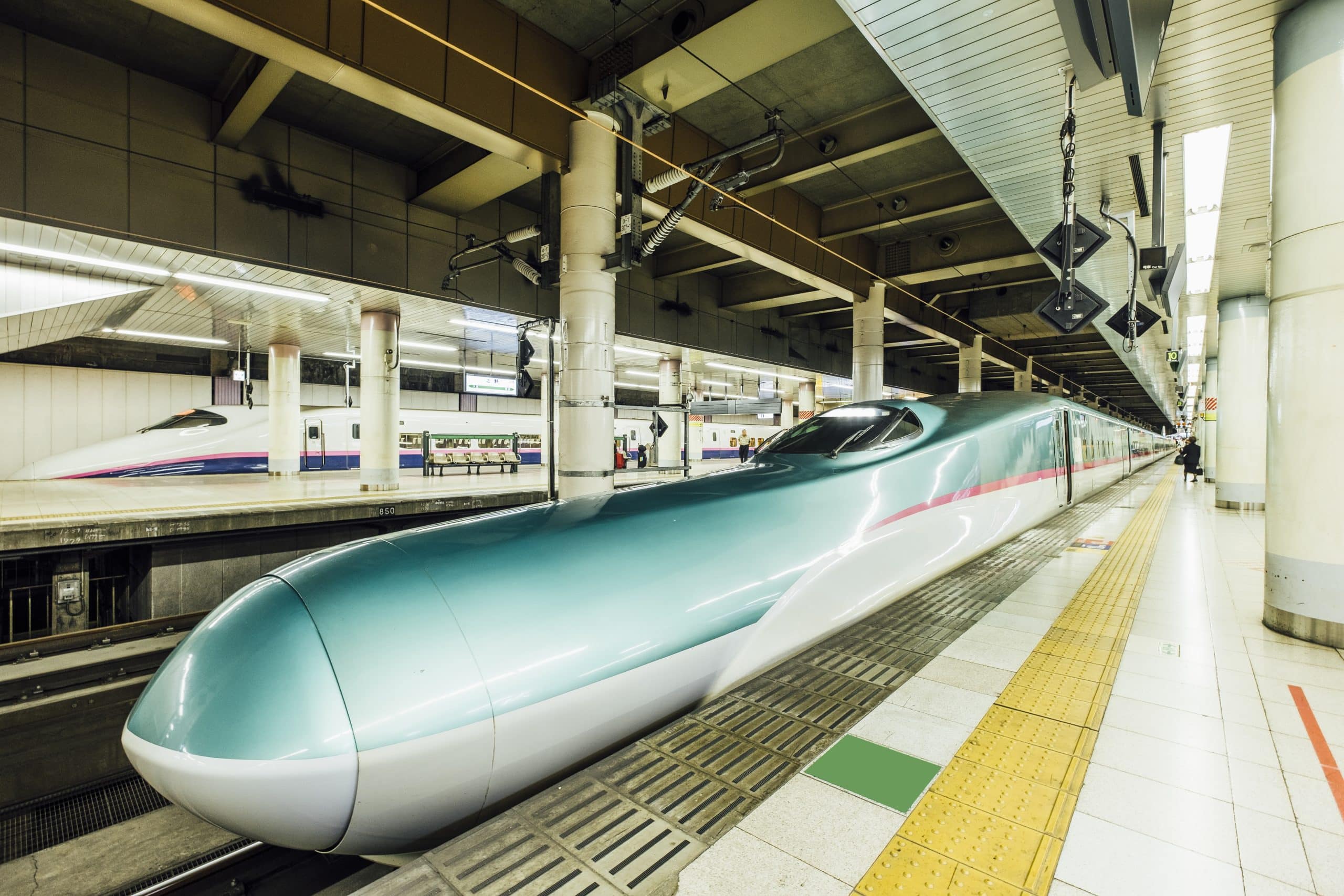 A Shinkansen bullet train stopped at a station platform