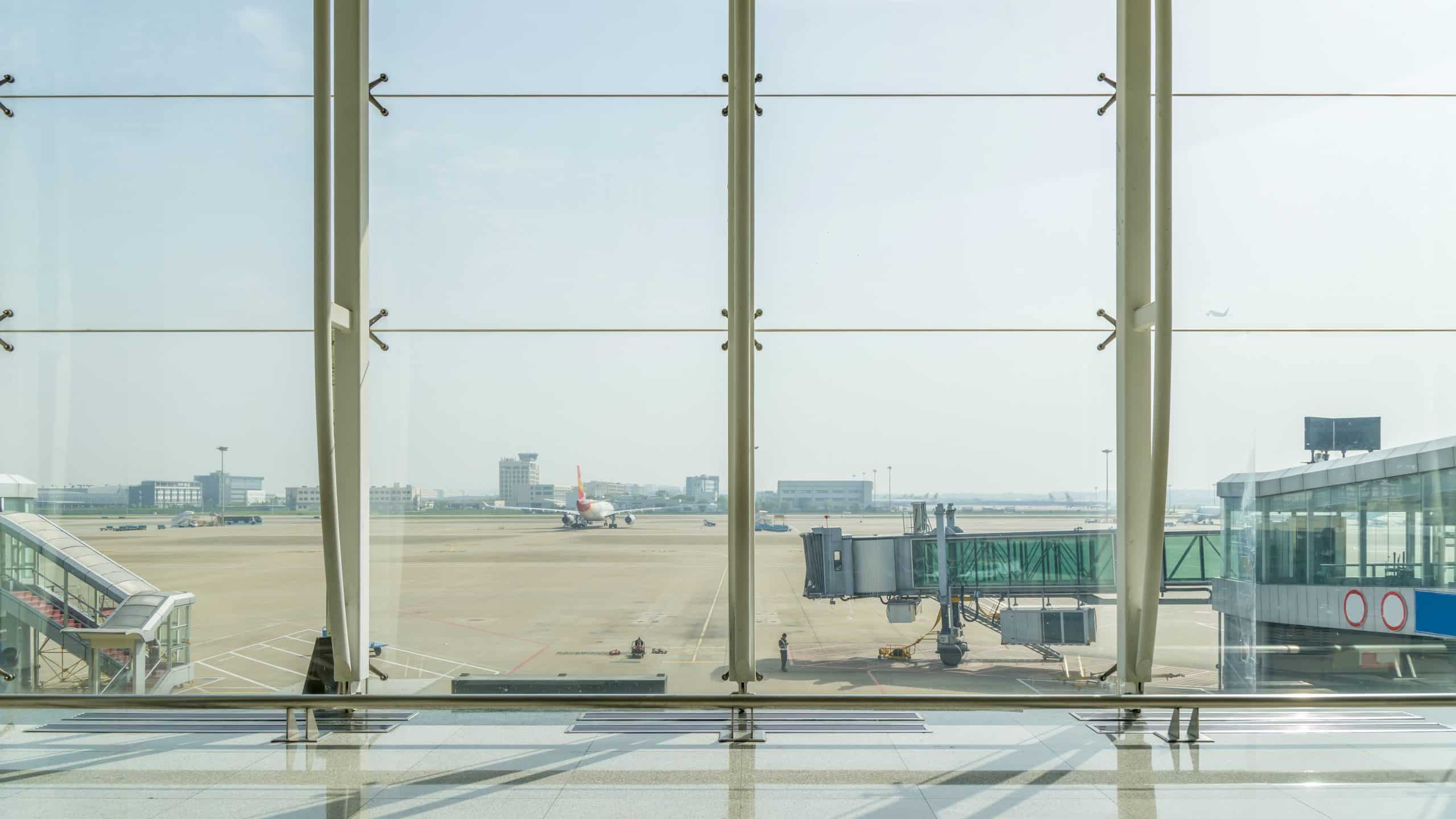 Wide glass-roofed airport terminal hall
