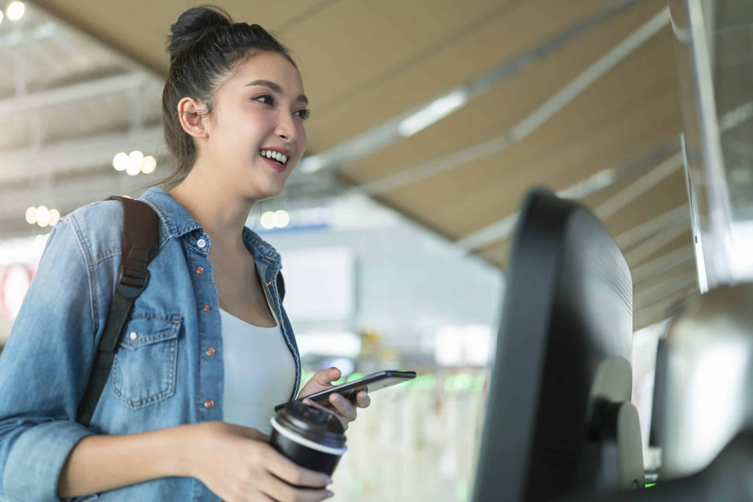 Traveler using a self-service check-in kiosk at an airport