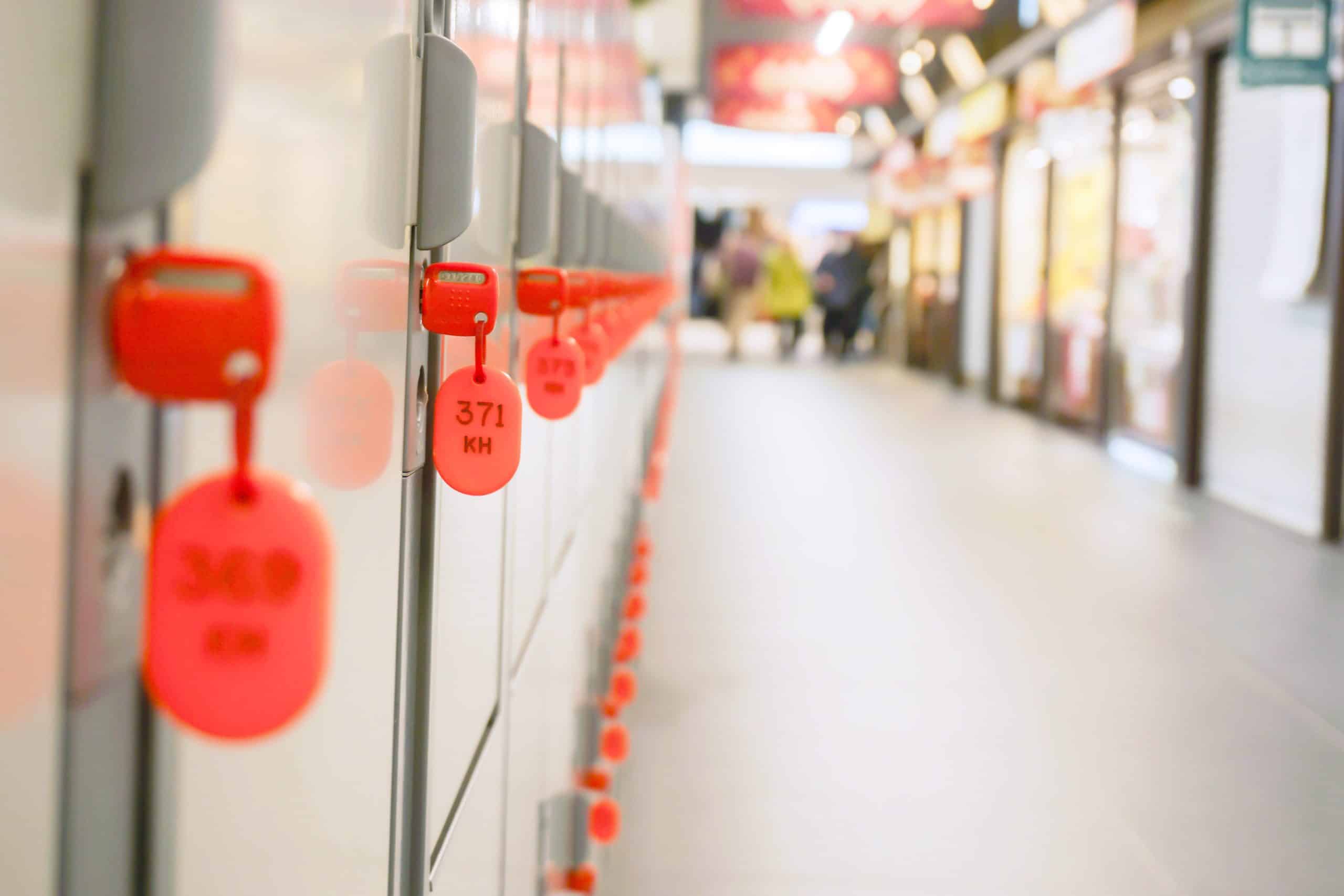A numbered coin locker key hanging from its lock at a Japanese railway station, used to reopen the locker after payment