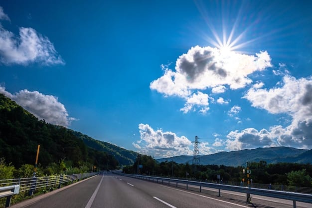 A curved elevated expressway winding through green hills in Hokkaido, Japan