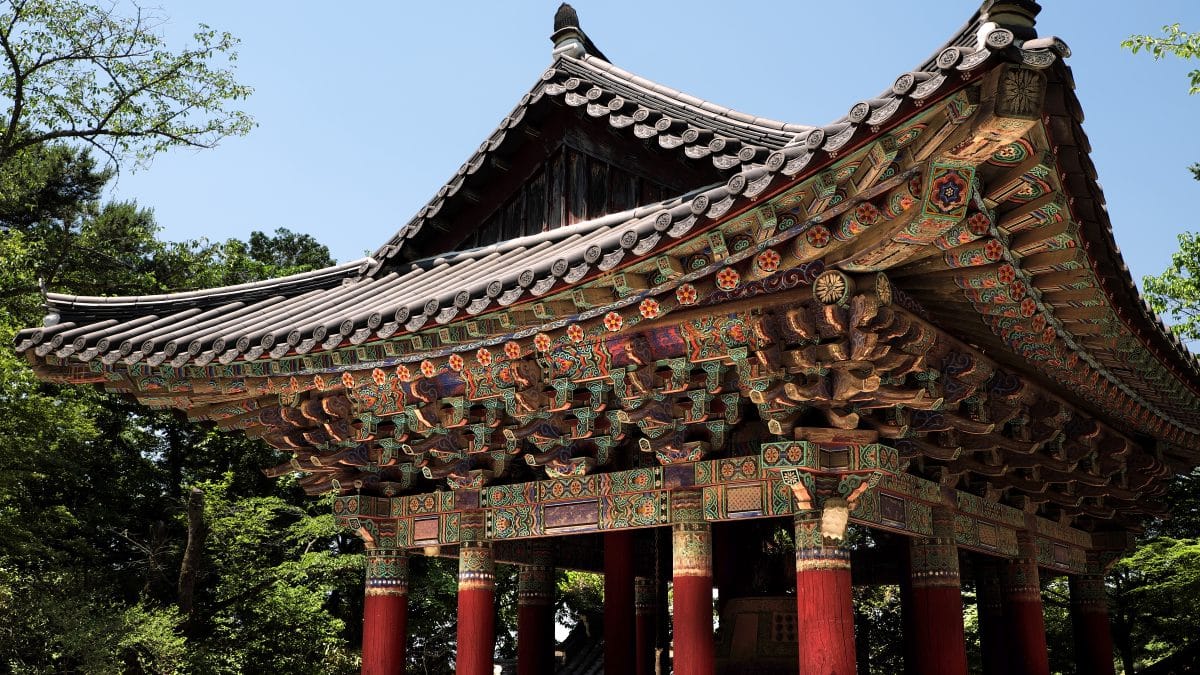Tiled roofs of Bulguksa Buddhist temple in Gyeongju, South Korea, with a stone pagoda and bell