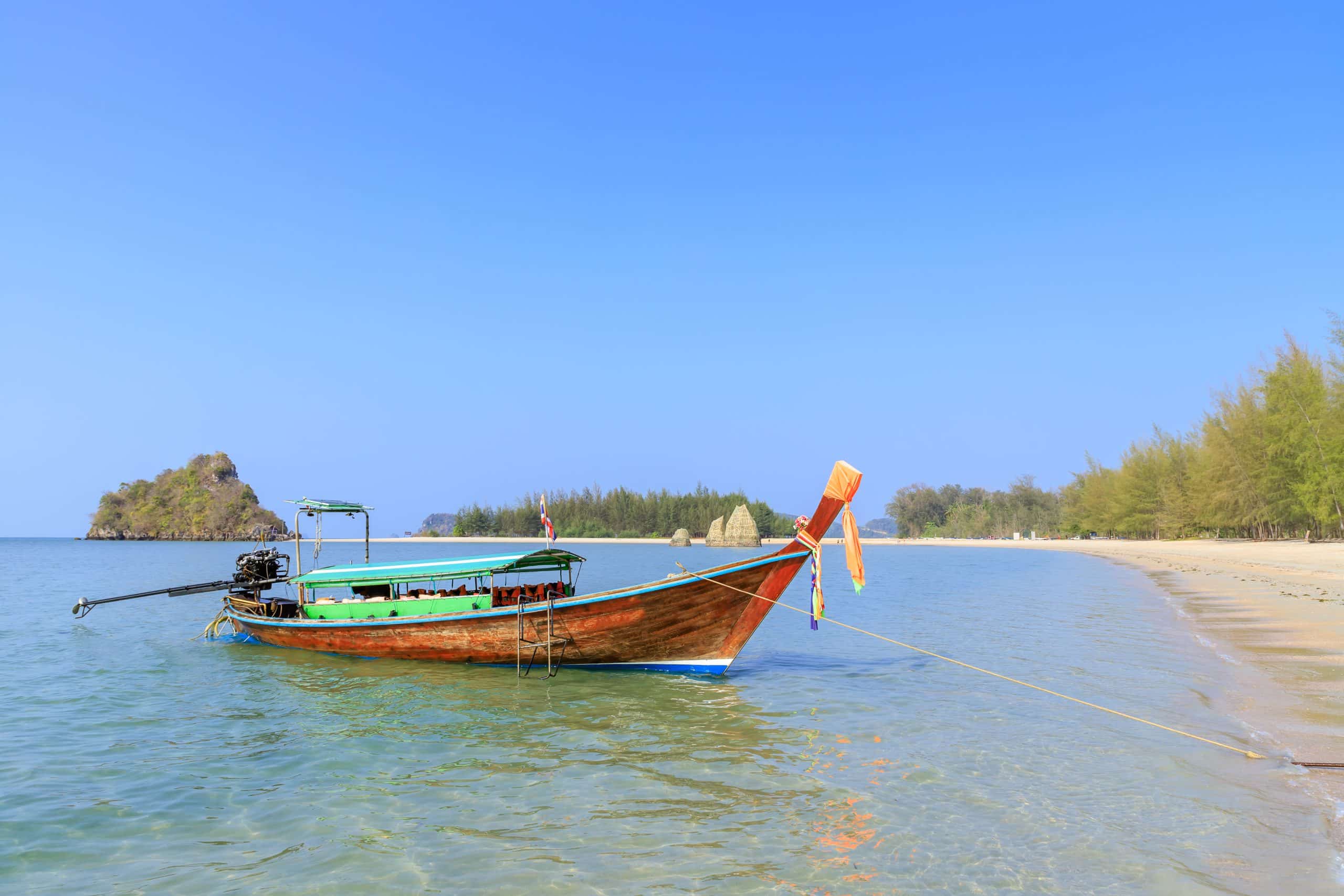 Longtail boat waiting for passengers at Noppharat Thara beach on the Andaman coast of Krabi
