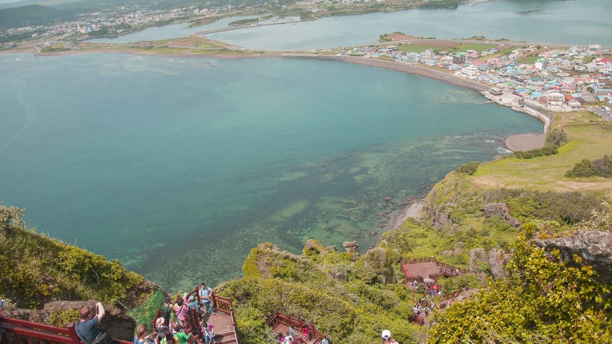 Seongsan Ilchulbong tuff cone rising from the sea on the east coast of Jeju Island