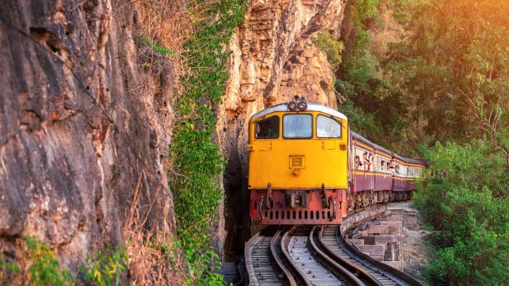Old Thai passenger train on the railway at Kanchanaburi, Thailand
